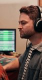 Man, editing and producer with headphones, music and listening to audio, recording and entertainment. Creative, electronic and production for sound engineer, bass and person with equipment and media - Powered by Shutterstock - Get 15% off with code: PIKWIZARD15