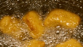 Closeup slow motion crispy fried chicken meat nuggets deep frying in boiling oil - Powered by Shutterstock - Get 15% off with code: PIKWIZARD15