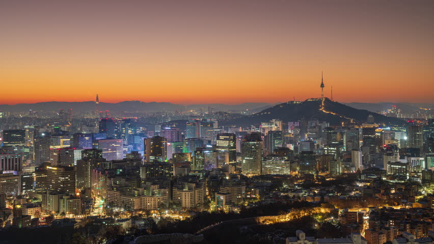 Golden morning light and Seoul city view, Namsan Tower and Lotte World Tower can be seen, Inwangsan, Seoul, South Korea.