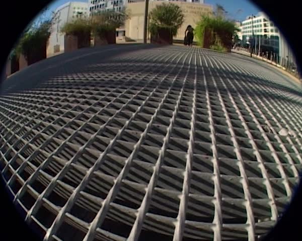 Vintage fisheye camcorder shot, a skateboarder does tricks in the street, Marseille, France