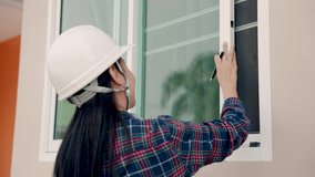Asian woman is a home inspector in a new home construction project, checking the house structure, neatness, checking by checking from the preliminary list, receiving efficient house before delivery. - Powered by Shutterstock - Get 15% off with code: PIKWIZARD15