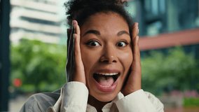Close up excited African American woman face expression surprised happy smiling laughing female girl businesswoman outdoor shocked amazed open mouth manager holding head business city wonder good news - Powered by Shutterstock - Get 15% off with code: PIKWIZARD15
