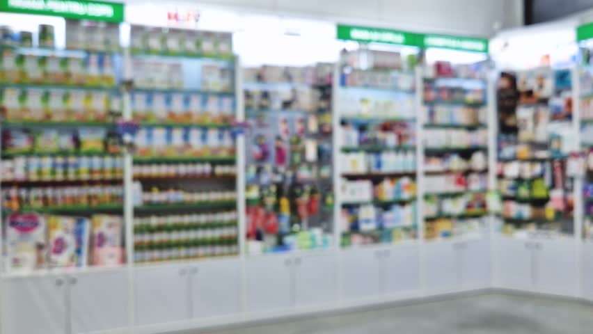 Blurred view of pharmacy stocked shelves. Healthcare and cosmetics industry defocused background
