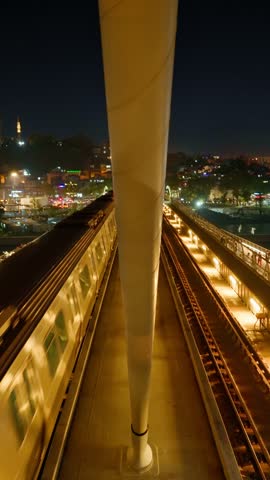 Istanbul night city view, Turkey, train at metro station on bridge over Golden Horn Bay, at night, arrival or departure
