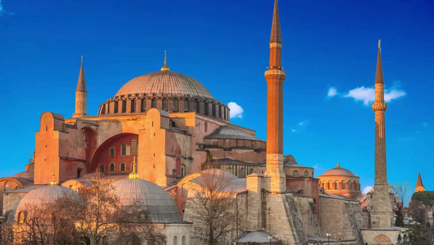 Hagia Sophia is an ancient religion symbol of Istanbul at sunrise. Ayasofya was the greatest Christian temple of Byzantium Empire. Famous Turkish Mosque with foth minarets and birds over the dome.