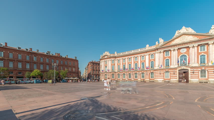 Panorama showing the Capitole de Toulouse timelapse showcases the historic city hall and municipal heart of Toulouse, France, located at Place du Capitole under a stunning blue cloudy sky