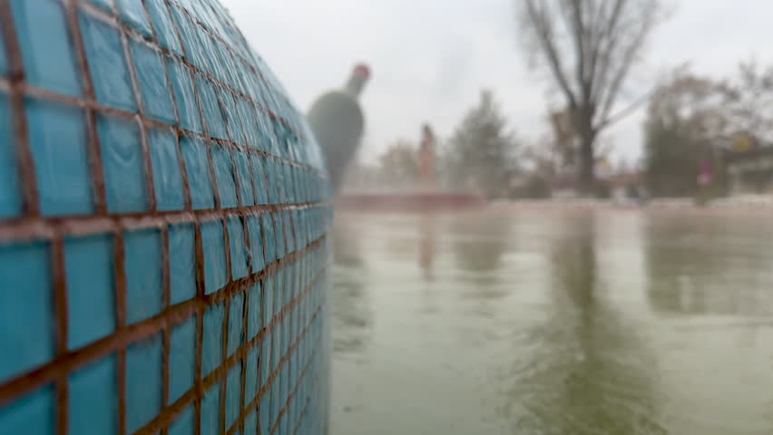 Hot thermal water gushes from the spring and flows down the pool creating a pleasant steam around the thermal resort. The concept of spa, wellness, relaxation