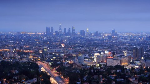 Los Angeles city timelapse. Transition from dusk to night. View from Hollywood Hills on freeway 101, zoom-in on downtown LA.