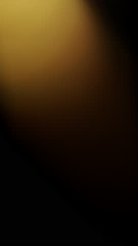 Soft glowing yellow and orange bokeh orbs gently floating and shimmering against a dark black background, creating a warm, calming ambiance