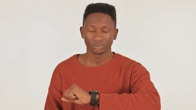 Portrait of Waiting Young African Man Checking Time on White Background - Powered by Shutterstock - Get 15% off with code: PIKWIZARD15