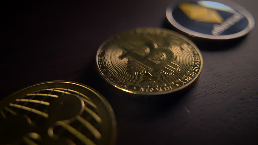 Glistening Cryptocurrency Coins Displayed on a Dark Surface for Enhanced Visual Impact
