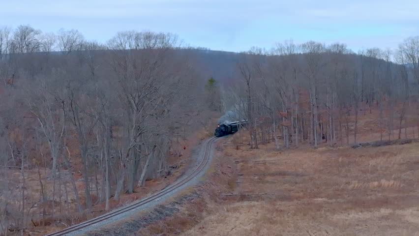 Train Travels Through Tranquil Countryside in Winter Setting