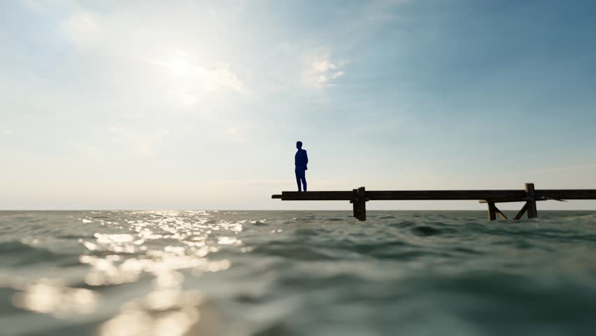 Businessman standing alone on the seashore thinking about life