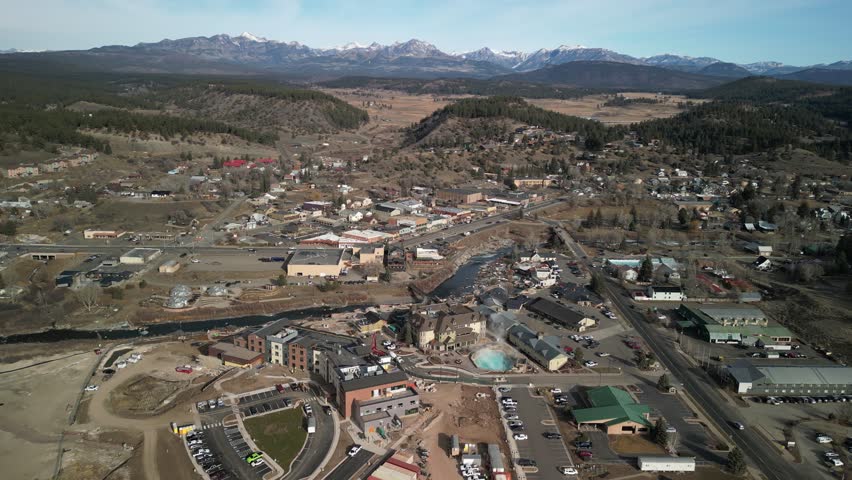 Wide aerial above mountain town of Pagosa Springs Colorado in winter