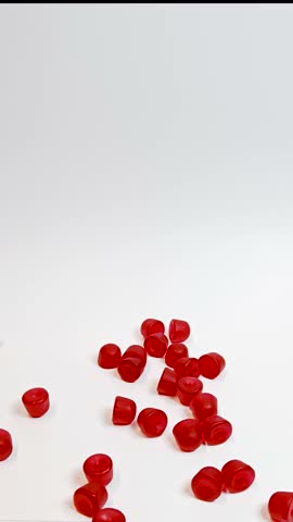 Gummies falling onto a white surface
