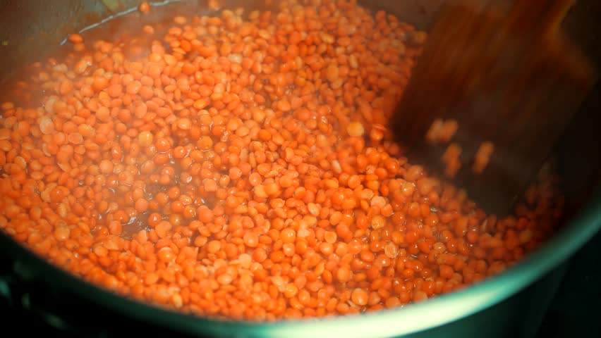 Stirring Pot Of Red Lentil Soup. Hot Dish Lunch Traditional Dominican Creole Meal. Sancocho Gourmet Dish. Stirring Boiling Pot Vegetable And Chicken Lentil Soup.Yellow Vegetables Lentil Soup On Stove