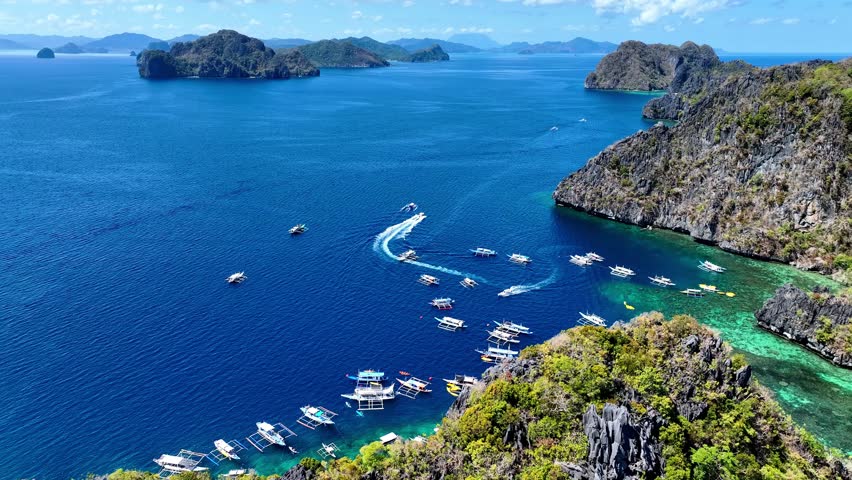 Aerial top view of Traditional filipino boat bangka or banca at the blue lagoon in El Nido province, Palawan island in Philippines	