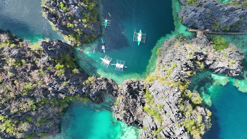 Aerial top view of Traditional filipino boat bangka or banca at the blue lagoon in El Nido province, Palawan island in Philippines