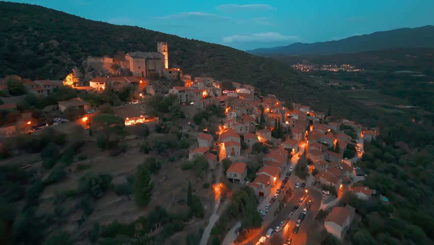 Aerial view of Eus at night, the medieval hilltop town in Pyrenees mountains, France, one of the most beautiful villages of France and a popular tourist destination