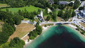 Aerial view of tourists enjoying summer holidays, swimming and kayaking on the beautiful lake bohinj, surrounded by the julian alps in slovenia - Powered by Shutterstock - Get 15% off with code: PIKWIZARD15