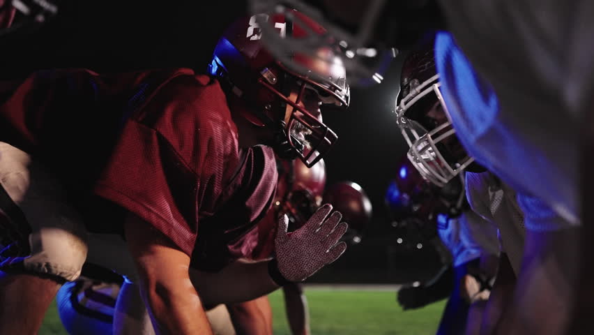 American Football Championship Start Teams Ready: Professional Players, Aggressive Face-off, Start Pushing, Tackling. Competition Full of Brutal Energy, Skill. Cinematic Slow Motion. Dramatic Sport