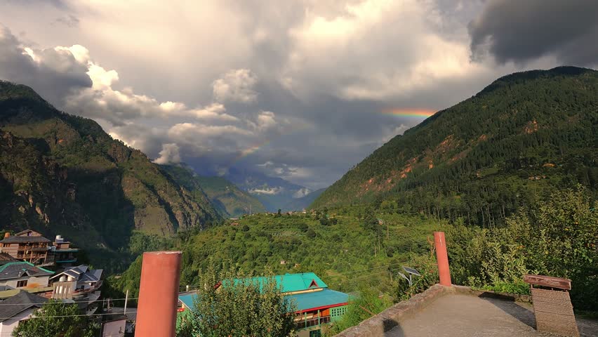 Beautiful timelapse shot of a village near kasol in Parvati valley with old rustic houses at the foothills of Himalayas in Himachal Pradesh, Indi