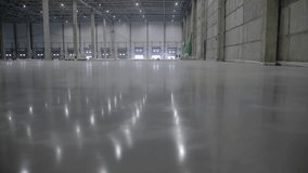 Expansive and Spacious Industrial Warehouse Featuring a Floor with Polished Reflection. Clip - Powered by Shutterstock - Get 15% off with code: PIKWIZARD15
