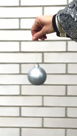 Feliz Navidad message and Christmas Ornament Held by Hand