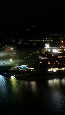 cruise ship docked moored port invergordon night dark waters reflect ship's lights creating visual forward aerial view drone shot travel holiday adventure vessel harbor scenic nature