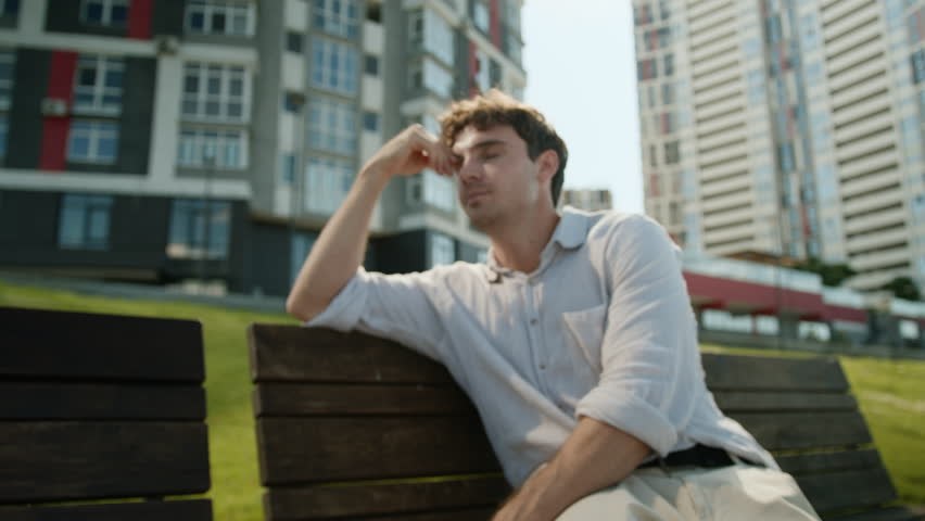 Caucasian man scratch head problems guy businessman business male difficulties thoughtful pensive crisis uncertain city thinking confused puzzled work ponder job sitting bench career bankrupt outdoors