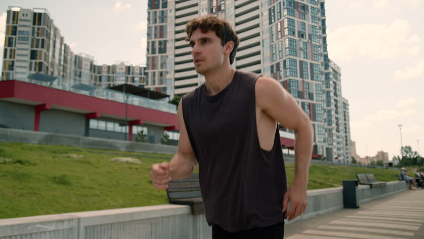 Caucasian man sportsman athlete running runner jog jogger sport sportive movement active street outdoors male motivation training exercise strong guy healthy lifestyle sportswear city fitness workout