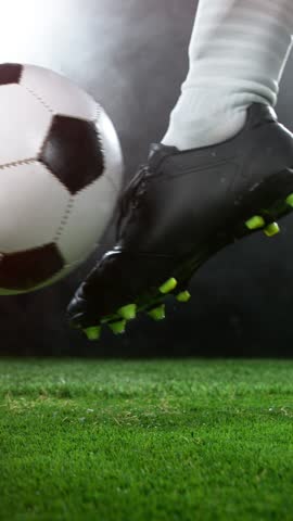 Super Slow Motion of Soccer Player Kicking the Ball, Close-up. Filmed on High Speed Cinema Camera, 1000fps. Vertical Aspect Ratio.