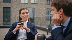 Businesswoman businessman sipping coffee at friendly meeting at rooftop restaurant closeup. Smiling colleagues drinking talking at work break outdoors. Coworkers enjoying relaxed conversation in cafe. - Powered by Shutterstock - Get 15% off with code: PIKWIZARD15