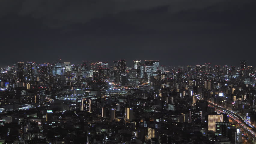 osaka city skyline establishing aerial shot at night,view of umeda downtown ward from distance