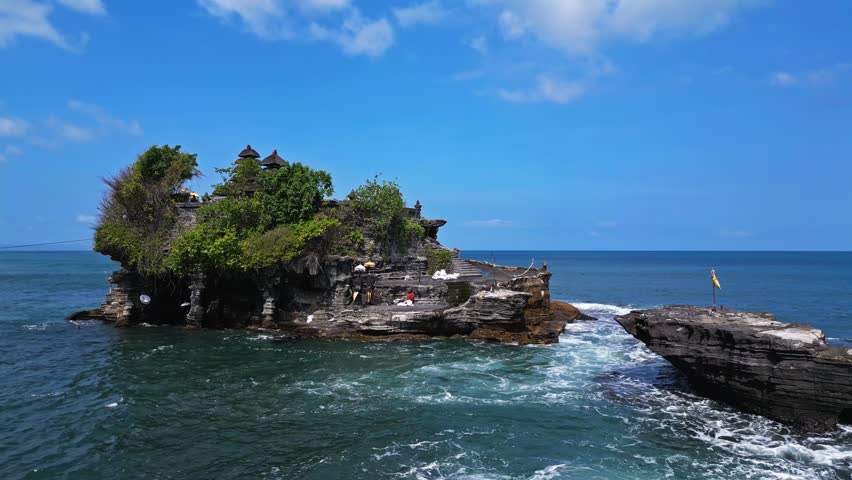 Heart of Bali, where ocean’s caress meets sky’s embrace, lies Tanah Lot