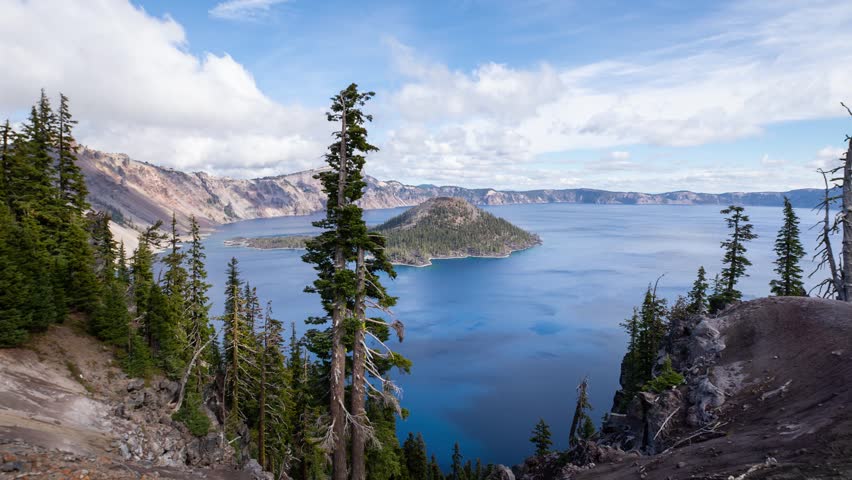 Time lapse of puffy clouds moving across the sky above Crater Lake in Oregon