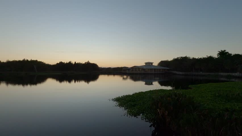 Green Cay Wetlands Nature Preserve, Boynton Beach, Florida - Dolly across the marsh with visitor center in the background before sunrise