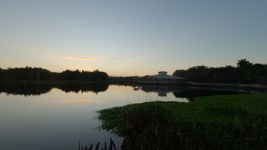 Green Cay Wetlands Nature Preserve, Boynton Beach, Florida - Dolly across the marsh with visitor center in the background before sunrise