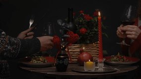 Couple in love celebrates St. Valentines Day by clinking glasses of red wine during romantic candlelit dinner - Powered by Shutterstock - Get 15% off with code: PIKWIZARD15