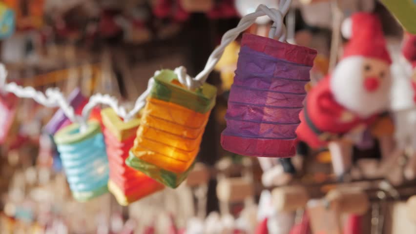 Christmas tree garland made of paper. Warm flashlight light and eco-friendly materials. New Years toys, ornaments and decor. Christmas market shopping.
