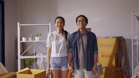Portrait slow-motion of happy Asian couple in love moving in new home and feel proudly. - Powered by Shutterstock - Get 15% off with code: PIKWIZARD15