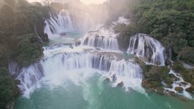 Aerial view of majestic Ban Gioc Waterfall, Detian Falls flowing amidst tropical forest during the sunset at Cao Bang, Vietnam - Powered by Shutterstock - Get 15% off with code: PIKWIZARD15