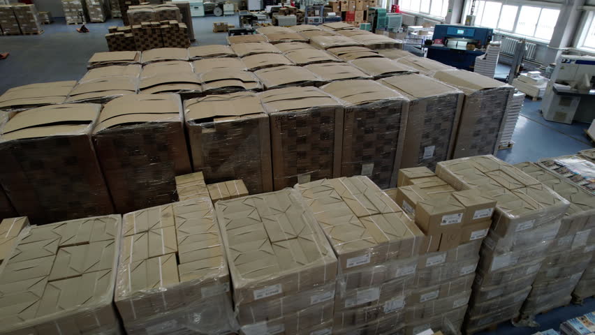 Spacious containerboard production warehouse with finished products. Warehouse stores finished products for further loading and transportation
