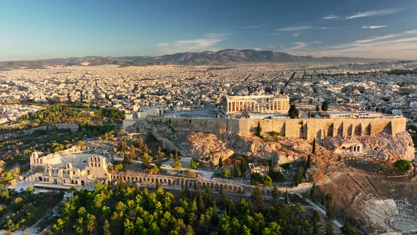 Fly above Iconic Parthenon and Surrounding Ancient Ruins in Athens, Greece. Aerial Views of Athens Showcasing Ancient Acropolis and Stunning City Landscape During Sunrise. UHD, 4K 