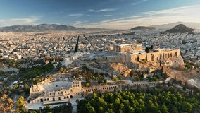 Fly above Iconic Parthenon and Surrounding Ancient Ruins in Athens, Greece. Aerial Views of Athens Showcasing Ancient Acropolis and Stunning City Landscape During Sunrise. UHD, 4K  - Powered by Shutterstock - Get 15% off with code: PIKWIZARD15