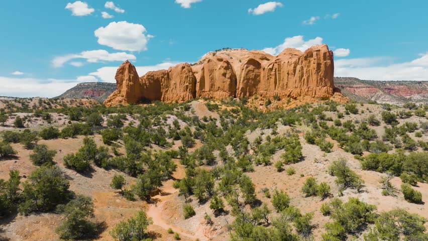 Drone shot of a rock formation plateau ahead of Mt Powell in Thoreau New Mexico nearby Galia Overlook in Navajo Nation territory approaching very low