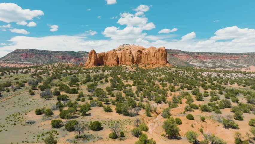 Drone shot of a rock formation ahead of Mt Powell in Thoreau New Mexico nearby Galia Overlook in Navajo Nation territory rising above it