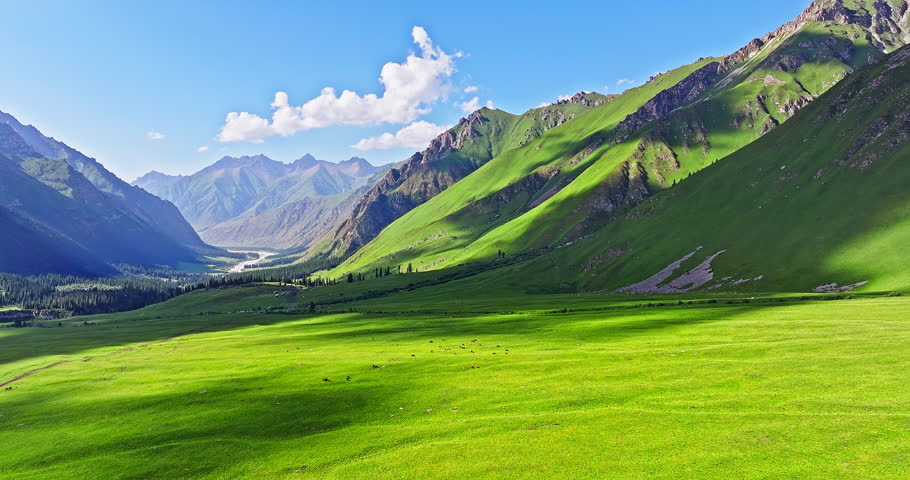 Green grassland with mountain natural landscape in Xiata Scenic Area, Xinjiang. Famous travel destinations in China. Summer scenery.