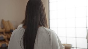 Women talking in a bakery, one woman serving as the employee while holding a tablet and the other as the customer with bread on shelves in the background and pastries on the counter - Powered by Shutterstock - Get 15% off with code: PIKWIZARD15