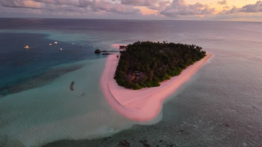 Aerial views of Velavaru Island at sunset in Maldives
